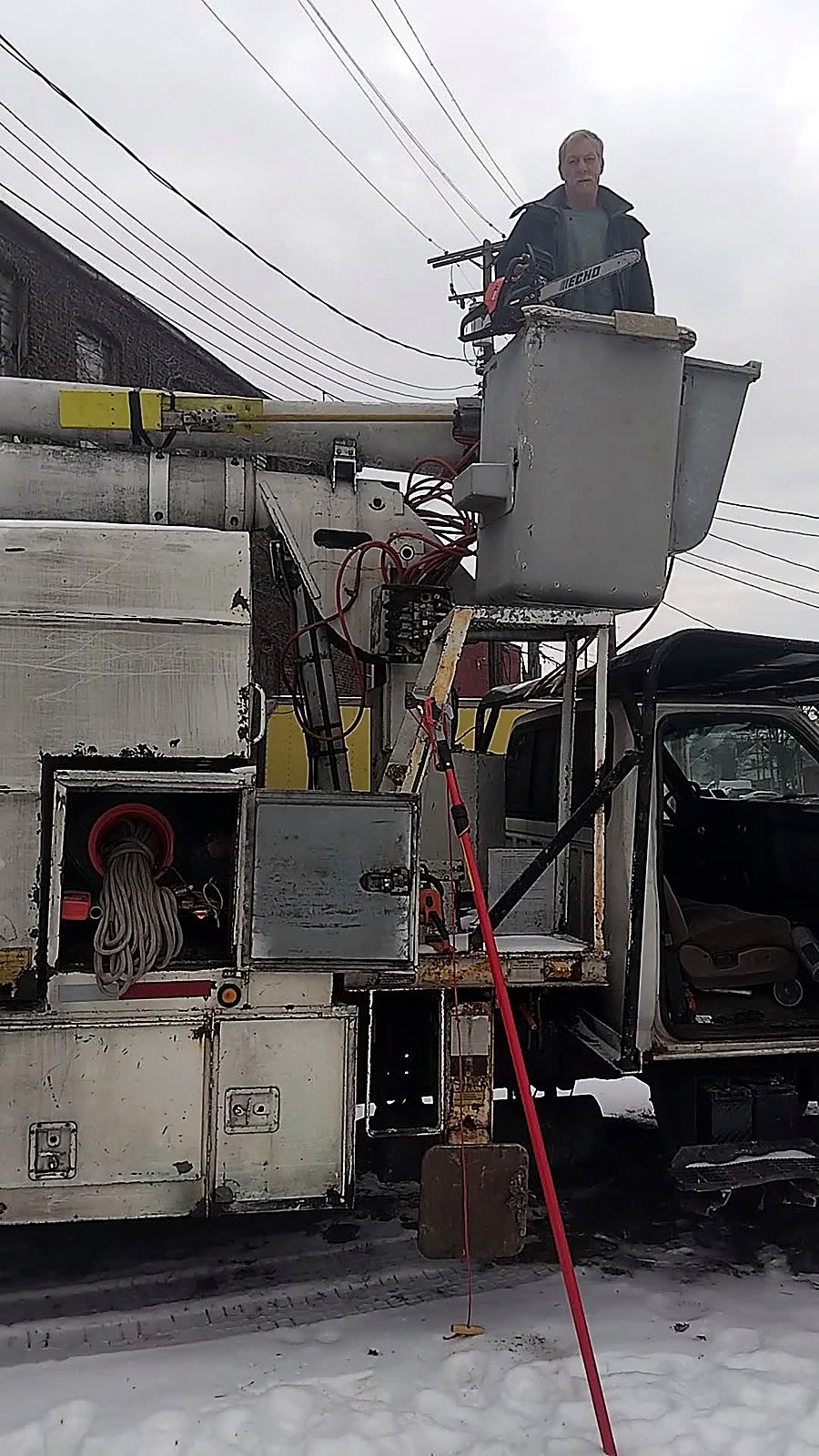 Keith, owner of Kenwood Tree Service, working from the bucket with his chainsaw